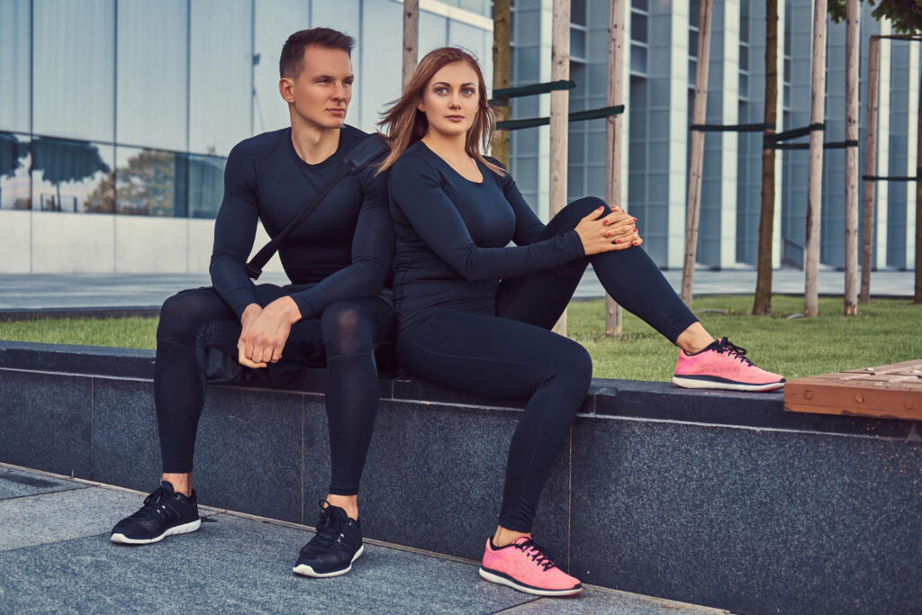 woman and man wearing tracksuits
